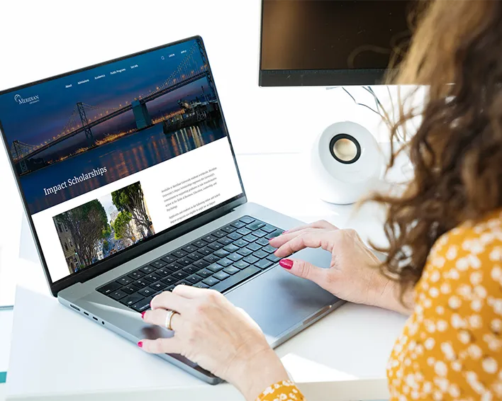 young woman smiling at computer