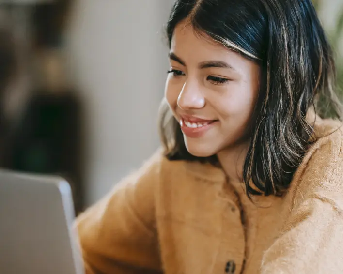young woman smiling at computer