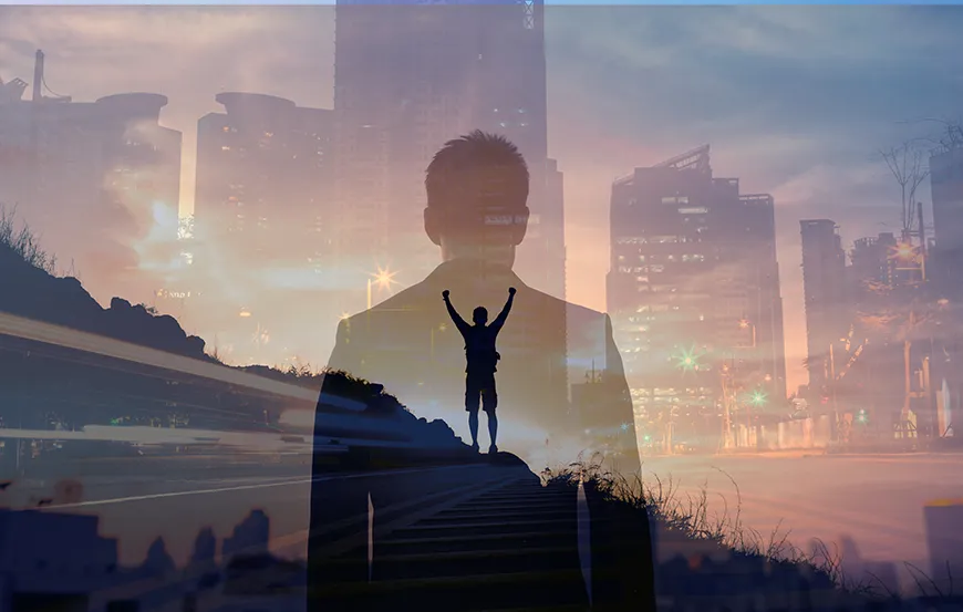 The transparent shape of a businessman overlaps with an image of a man standing triumphantly on a hill in front of the city.