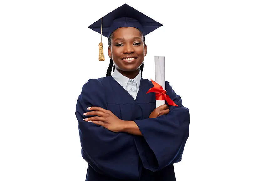 A happy graduate in her robe and cap stands proudly with her degree