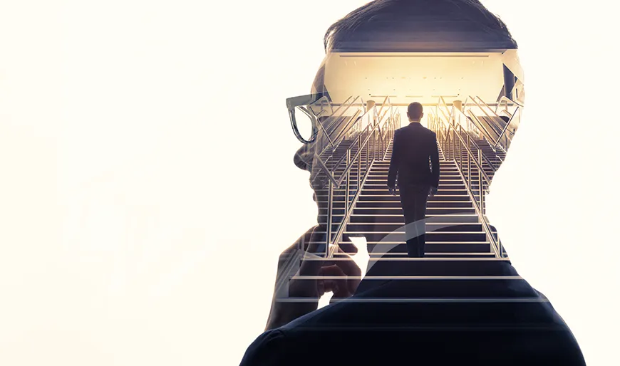 A contemplative businessman envisions his ascent up a flight of stairs toward an illuminated space.