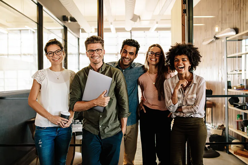 A group of young business professionals smiling for a photo