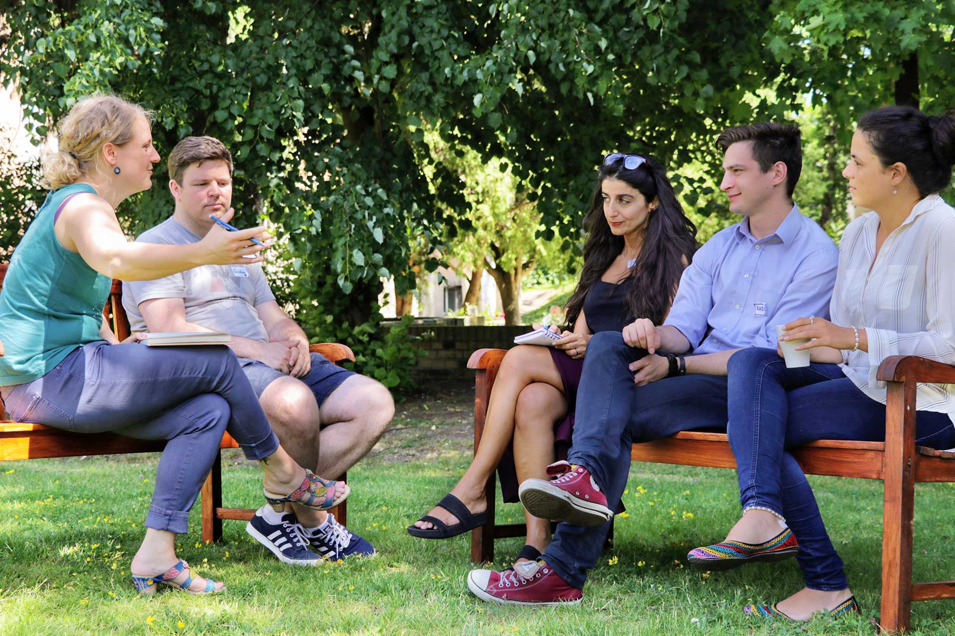 integral practitioners discussing outside on benches