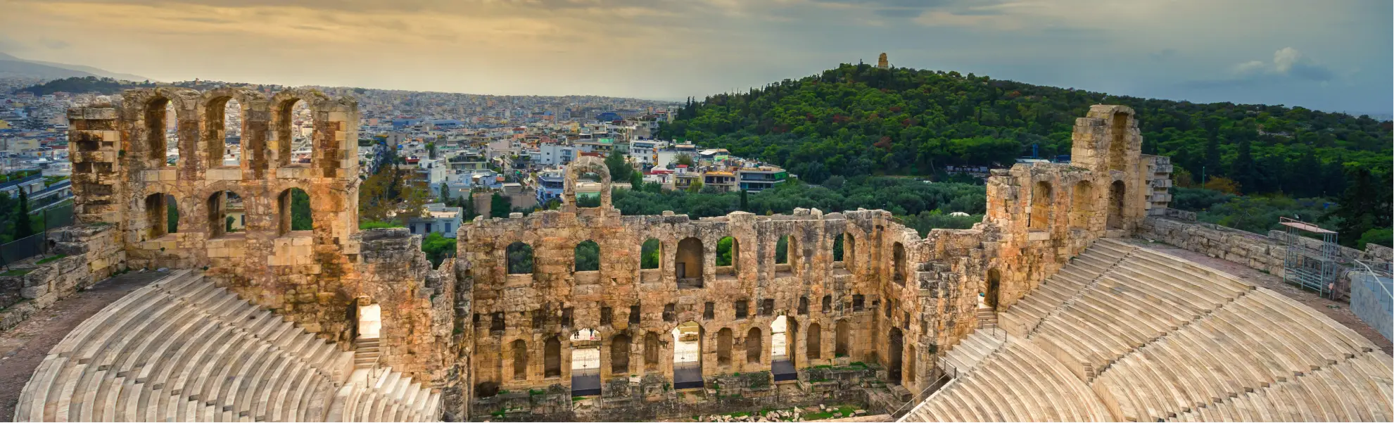 The ruins of a classic greek ampitheater over looking a modern city